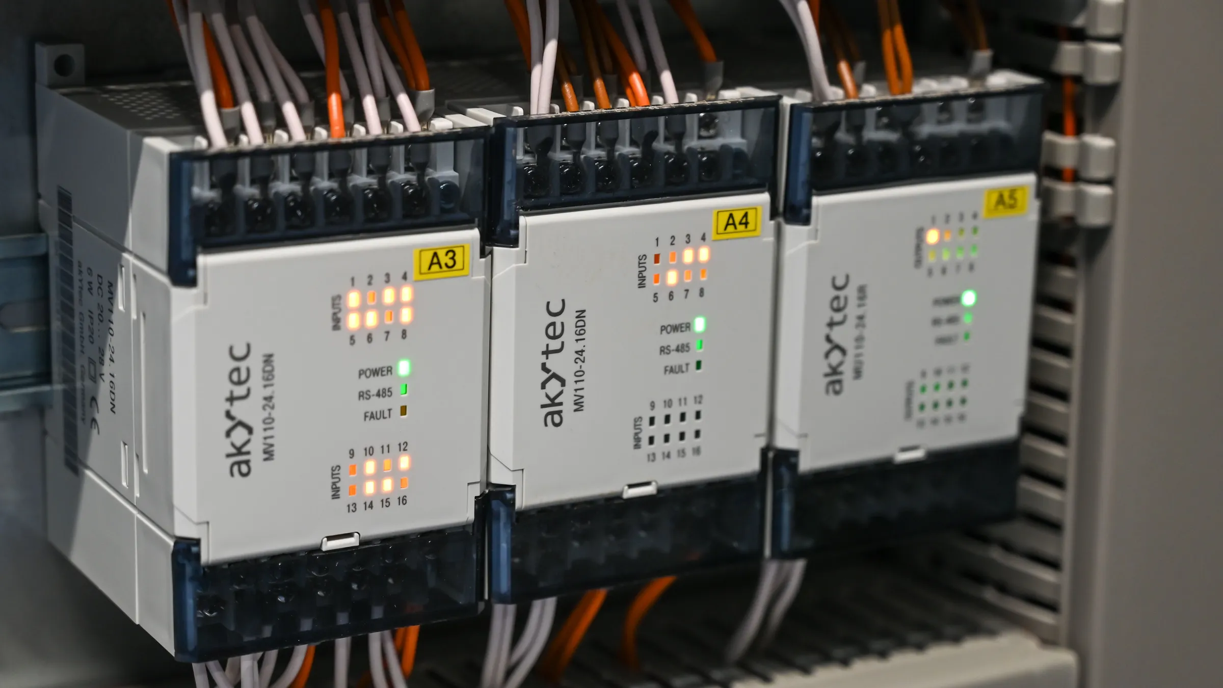 IO modules with orange wiring in a control cabinet