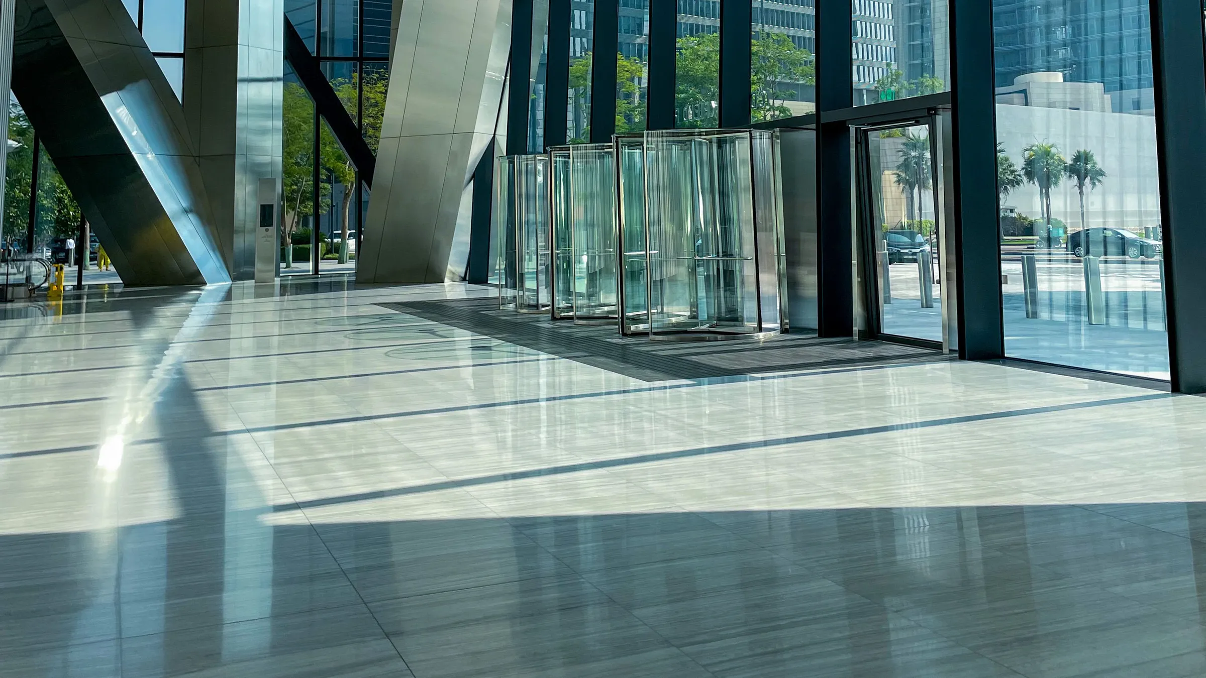 Bright glass office lobby with revolving doors